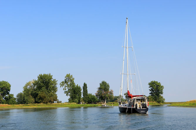 Sailboat anchored in a channel.