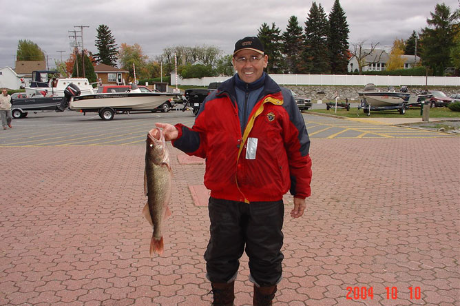 A man shows off the Walleye he has landed.