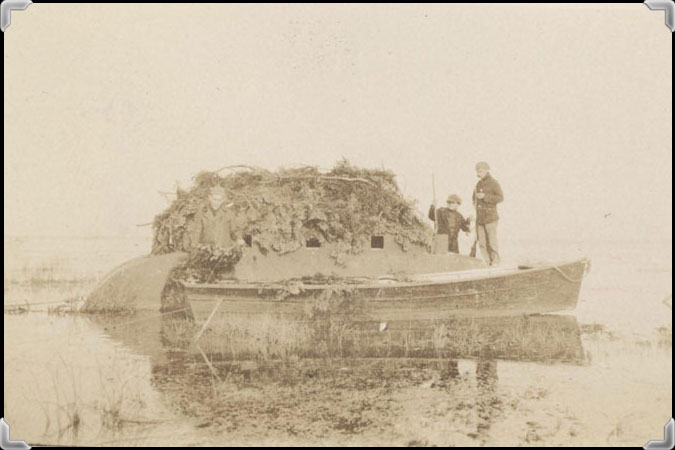 Two hunters near their blind, circa 1920