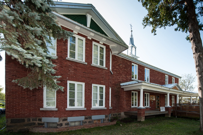 Exterior view of the old red-brick section of the Musée des Abénakis in Odanak
