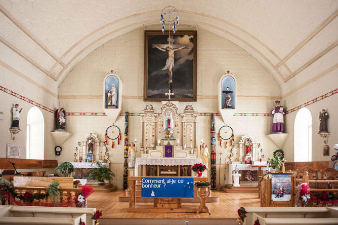 Interior view of Saint-François-de-Sales Church in Odanak, showing  a variety of religious symbols.